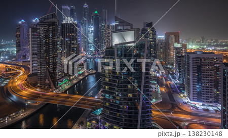 Aerial view of Dubai Marina residential and office skyscrapers with waterfront night timelapse Aerial view of Dubai Marina residential and office skyscrapers with waterfront night timelapse 138230148