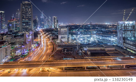 Construction activity in Dubai downtown with cranes and workers night timelapse, UAE. 138230149