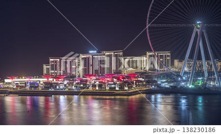 Bluewaters Island in Dubai aerial night timelapse with illuminated buildings. Bluewaters Island in Dubai aerial night timelapse with illuminated buildings. 138230186