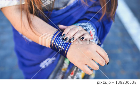 Indian woman wearing blue sari with bangles Indian woman wearing blue sari with bangles 138230338