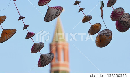 Vietnamese conical hats hanging with Moscow Kremlin in background Vietnamese conical hats hanging with Moscow Kremlin in background 138230353