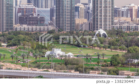 Dubai Golf Course with a cityscape of Greens and tecom districts at the background aerial timelapse Dubai Golf Course with a cityscape of Greens and tecom districts at the background aerial timelapse 138230447