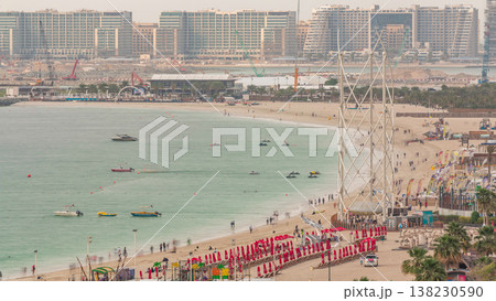 Aerial view of beach and tourists walking and sunbathing on holiday in JBR timelapse in Dubai, UAE Aerial view of beach and tourists walking and sunbathing on holiday in JBR timelapse in Dubai, UAE 138230590