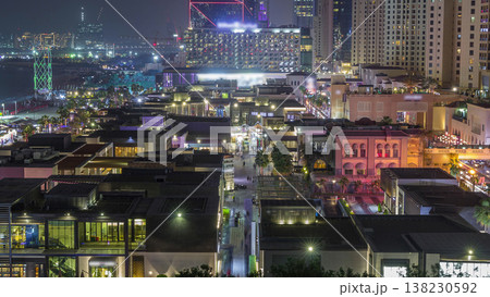 Aerial view of beach and tourists walking in JBR with skyscrapers night timelapse in Dubai, UAE 138230592