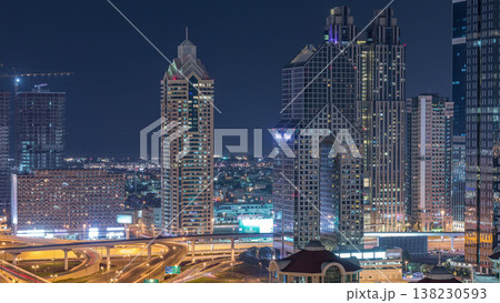 Aerial view of illuminated skyscrapers and road junction in Dubai timelapse 138230593