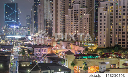 Aerial view of beach and tourists walking in JBR with skyscrapers night timelapse in Dubai, UAE Aerial view of beach and tourists walking in JBR with skyscrapers night timelapse in Dubai, UAE 138230598