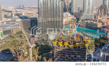 Aerial view of a skyscraper under construction with huge cranes timelapse in Dubai. Aerial view of a skyscraper under construction with huge cranes timelapse in Dubai. 138230772