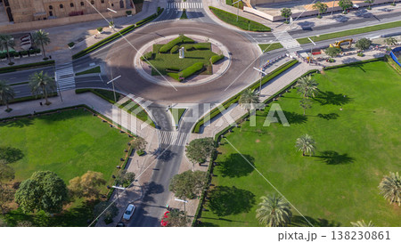 Aerial view of a roundabout circle road in Dubai downtown from above timelapse. Dubai, United Arab Emirates. Aerial view of a roundabout circle road in Dubai downtown from above timelapse. Dubai, United Arab Emirates. 138230861