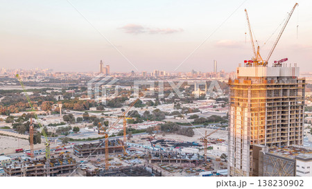 Construction activity in Dubai downtown with cranes and workers timelapse, UAE. Construction activity in Dubai downtown with cranes and workers timelapse, UAE. 138230902