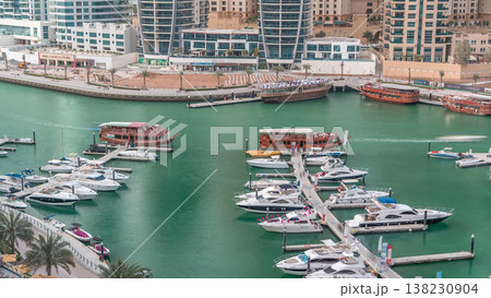 Luxury yachts parked on the pier in Dubai Marina bay with city aerial view timelapse Luxury yachts parked on the pier in Dubai Marina bay with city aerial view timelapse 138230904