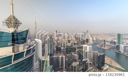 Panoramic aerial view of business bay towers in Dubai at evening timelapse. Panoramic aerial view of business bay towers in Dubai at evening timelapse. 138230961