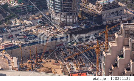 Under construction high-rise building with yellow construction crane in Dubai timelapse Under construction high-rise building with yellow construction crane in Dubai timelapse 138231125