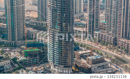 Under construction high-rise building with yellow construction crane in Dubai timelapse Under construction high-rise building with yellow construction crane in Dubai timelapse 138231136