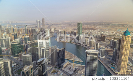 Panoramic aerial view of business bay towers in Dubai at evening timelapse. Panoramic aerial view of business bay towers in Dubai at evening timelapse. 138231164