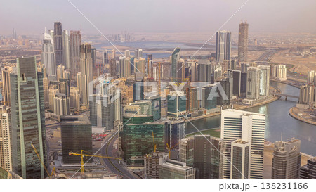 Panoramic aerial view of business bay towers in Dubai at evening timelapse. Panoramic aerial view of business bay towers in Dubai at evening timelapse. 138231166
