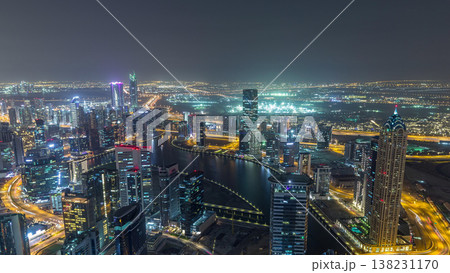 Panoramic aerial view of business bay towers in Dubai night timelapse. 138231170