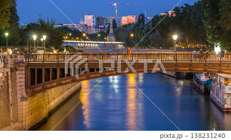 River and bridge near Notre Dame De Paris cathedral day to night timelapse after sunset. 138231240