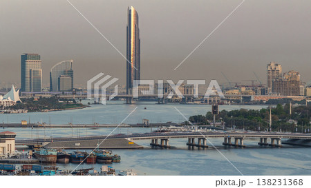 Dubai creek landscape timelapse with boats and ship in port and modern buildings in the background during sunset Dubai creek landscape timelapse with boats and ship in port and modern buildings in the background during sunset 138231368