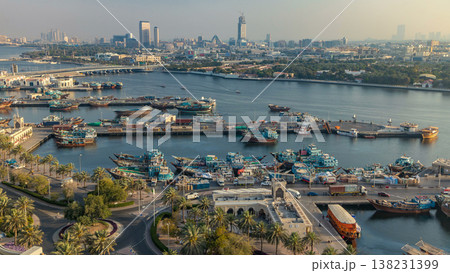 Dubai creek landscape timelapse with boats and ship in port and modern buildings in the background during sunset 138231399