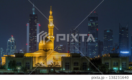 Modern Dubai city skyline timelapse with Rashid Al Hadeeth Mosque at night with illuminated skyscrapers over water surface Modern Dubai city skyline timelapse with Rashid Al Hadeeth Mosque at night with illuminated skyscrapers over water surface 138231640