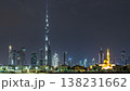 Modern Dubai city skyline timelapse at night with illuminated skyscrapers over water surface 138231662