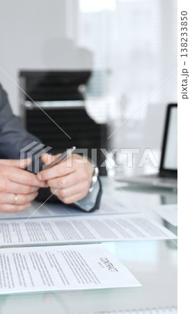 Business people engaging in a meeting, discussing important contract terms and financial agreements, clarifying legal details, signing documentation, and collaborating on corporate projects 138233850