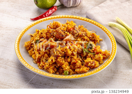 Savory fried rice with pork and vegetables on a plate with fresh lime, garlic, and chili Savory fried rice with pork and vegetables on a plate with fresh lime, garlic, and chili 138234949