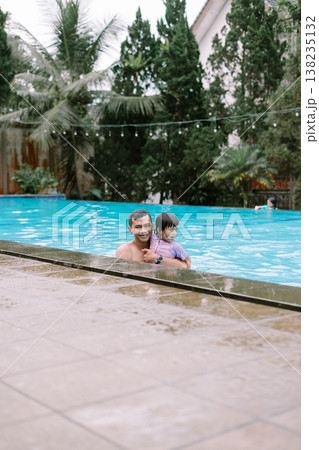Smiling Father and Daughter Swimming on Sunny Day Smiling Father and Daughter Swimming on Sunny Day 138235132