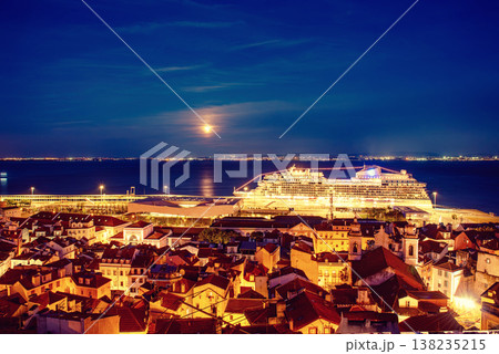 View Of Lisbon Skyline Old Historical City In Portugal, Alfama at night with port and ferry ship View Of Lisbon Skyline Old Historical City In Portugal, Alfama at night with port and ferry ship 138235215
