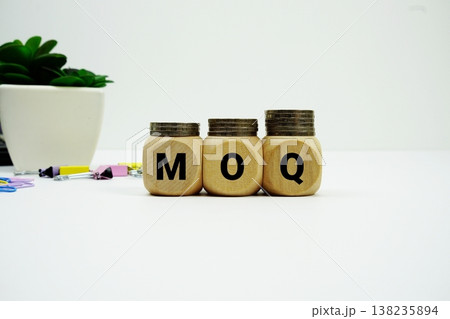 Stack of coins with wood blocks with "MOQ (Minimum Order Quantity)" Financial concept Stack of coins with wood blocks with "MOQ (Minimum Order Quantity)" Financial concept 138235894