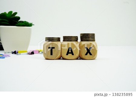 Stack of coins with wood blocks with "TAX" Financial concept Stack of coins with wood blocks with "TAX" Financial concept 138235895