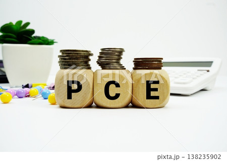 Stack of coins with wood blocks with "PCE (Personal Consumption Expenditures)" Financial concept 138235902