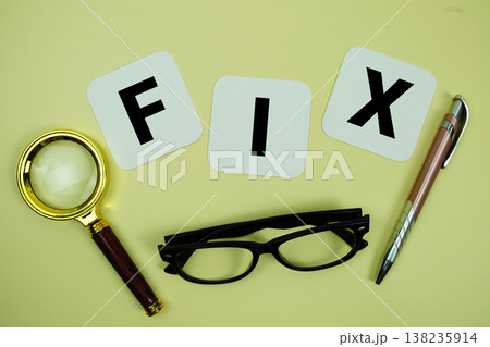 FIX alphabet letters with magnifying glass, eye glasses and pen on yellow background 138235914