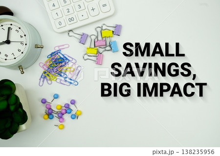 Small Savings, Big Impact message with calculator, alarm clock and Stationery on white background 138235956