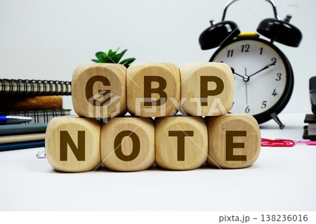 GBP Note alphabet letters with calculator and alarm clock on white background GBP Note alphabet letters with calculator and alarm clock on white background 138236016