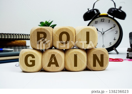 ROI Gain alphabet letters with calculator and alarm clock on white background ROI Gain alphabet letters with calculator and alarm clock on white background 138236023