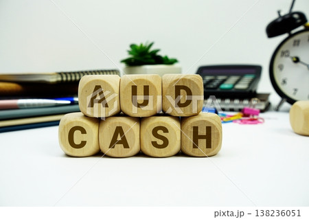 AUD Cash alphabet letters with calculator and alarm clock on white background 138236051