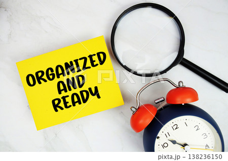 Organized And Ready text with sticky note and alarm clock flat lay on marble background 138236150