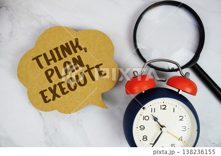 Think, Plan, Execute text with magnifying glass and alarm clock on marble background Think, Plan, Execute text with magnifying glass and alarm clock on marble background 138236155