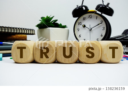 TRUST alphabet letters with alarm clock and calculator on white background TRUST alphabet letters with alarm clock and calculator on white background 138236159