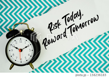 Risk Today, Reward Tomorrow text written on paper rip with alarm clock flat lay on turquoise chevron background 138236183