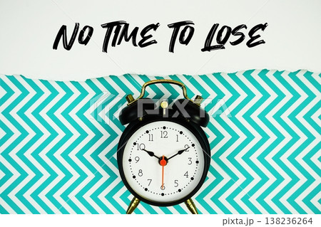 No Time To Lose text written on paper with alarm clock on green chevron background No Time To Lose text written on paper with alarm clock on green chevron background 138236264