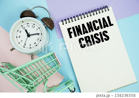Financial Crisis text written on notepad with alarm clock and trolley shopping cart Financial Crisis text written on notepad with alarm clock and trolley shopping cart 138236358