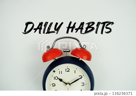 Daily Habits text with alarm clock flat lay on white background Daily Habits text with alarm clock flat lay on white background 138236371
