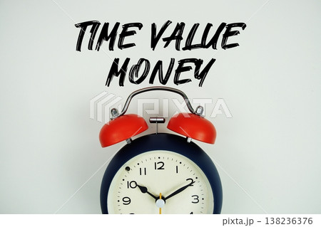 Time Value Money (TVM) text with alarm clock flat lay on white background Time Value Money (TVM) text with alarm clock flat lay on white background 138236376