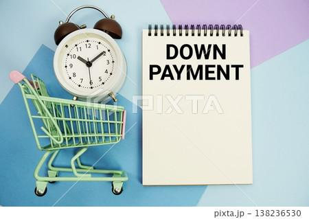 Down Payment text written on notepad with alarm clock and trolley shopping cart Down Payment text written on notepad with alarm clock and trolley shopping cart 138236530