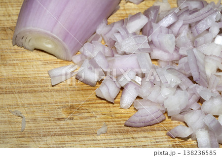 Close up of a chopped shallot onion on a wooden chopping board Close up of a chopped shallot onion on a wooden chopping board 138236585