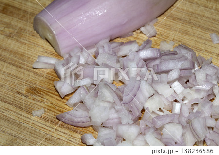Close up of a chopped shallot onion on a wooden chopping board Close up of a chopped shallot onion on a wooden chopping board 138236586