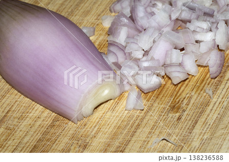 Close up of a chopped shallot onion on a wooden chopping board Close up of a chopped shallot onion on a wooden chopping board 138236588
