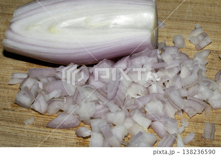 Close up of a chopped shallot onion on a wooden chopping board Close up of a chopped shallot onion on a wooden chopping board 138236590